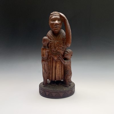 Lot 126 - An African carved wood sculpture depicting a...
