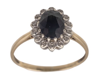 Lot 385 - A 9k sapphire and diamond cluster ring.