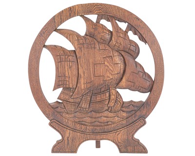Lot 717 - An arts and crafts carved oak fire screen.