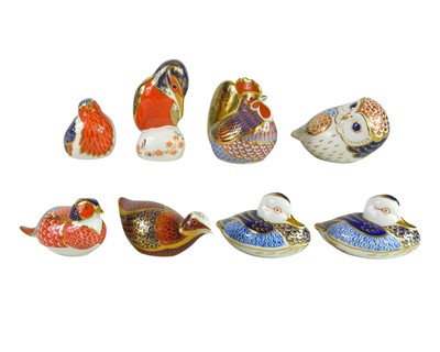 Lot 550 - Eight Royal Crown Derby bird paperweights.