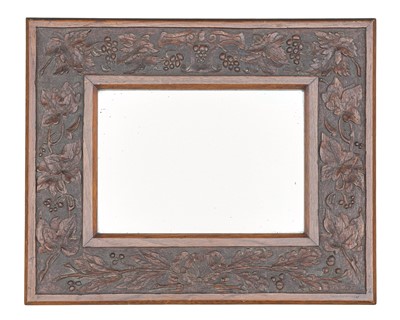 Lot 750 - An Arts and Crafts oak framed small wall mirror.