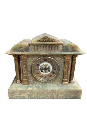 Lot 768 - A French onyx mantel clock.