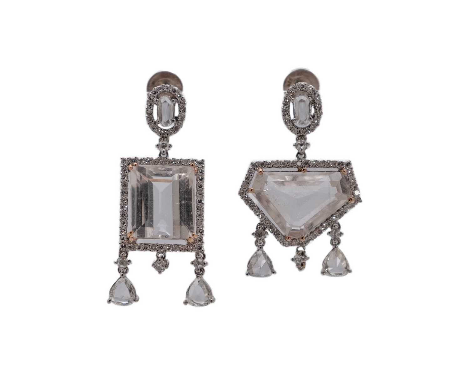 Lot A fine pair of 18k (tested) white gold, white zircon and diamond set cluster drop earrings.