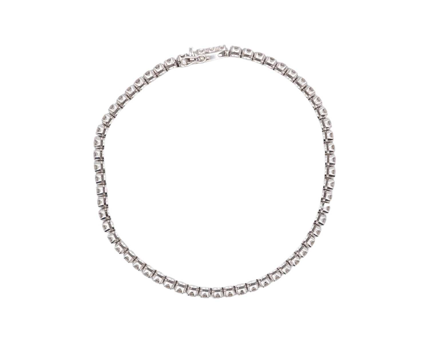 Lot 83 - A good 18k white gold diamond line bracelet.