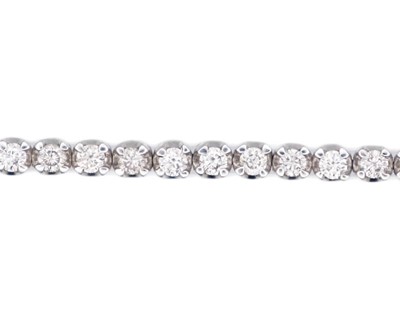 Lot 83 - A good 18k white gold diamond line bracelet.