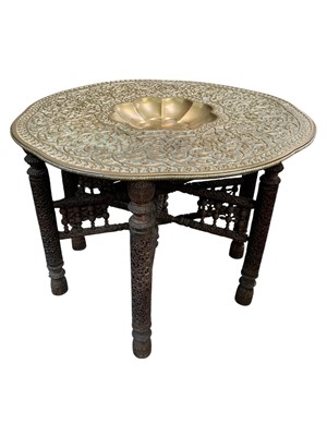 Lot 364 - An Anglo Indian brass top folding table.