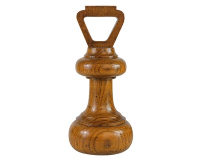 Lot 107 - An oak novelty doorstop.