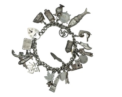 Lot 413 - A silver charm bracelet, applied with a good number of charms.