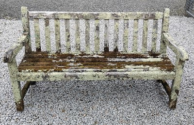 Lot 424 - A weathered, lichen covered, teak garden bench.