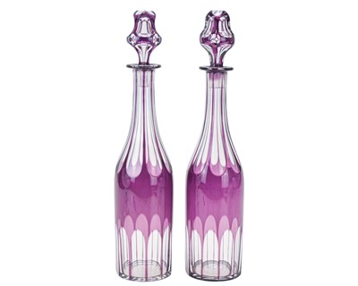 Lot 503 - A pair of Victorian amethyst overlay glass decanters and stoppers.