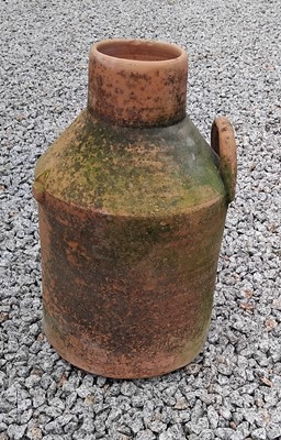 Lot 437 - A terracotta twin handled storage jar.