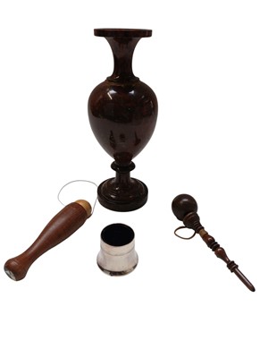 Lot 84 - A Cornish red serpentine turned baluster shape vase.