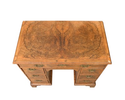 Lot 834 - A George II walnut kneehole desk or dressing table.