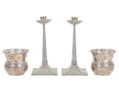 Lot 127 - A pair of Arts and Crafts pewter candlesticks.