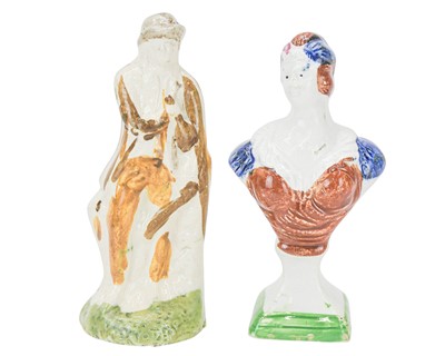 Lot 609 - A pearlware slip moulded figure of a man holding a bag.
