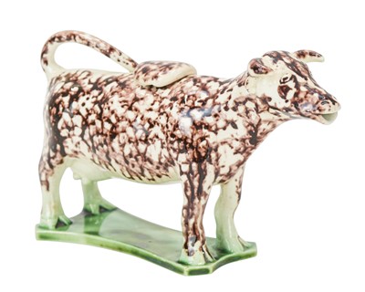 Lot 635 - A pearlware cow creamer and cover.