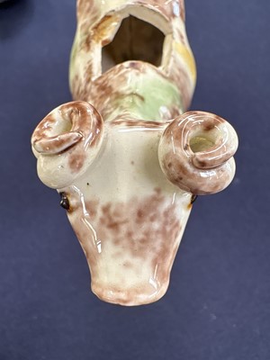 Lot 629 - A creamware Whieldon type cow creamer and cover.