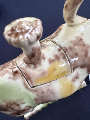 Lot 629 - A creamware Whieldon type cow creamer and cover.