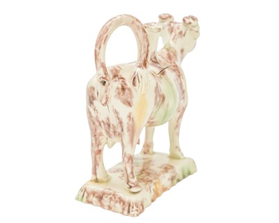 Lot 629 - A creamware Whieldon type cow creamer and cover.