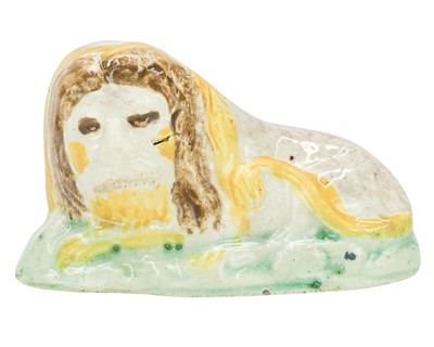 Lot 600 - A Pratt ware figure of a recumbent lion.