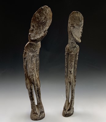 Lot 292 - A pair of African carved wood figures, bearing...