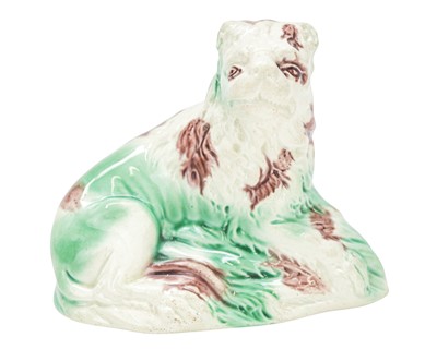Lot 634 - A Whieldon type pottery figure of a recumbent lion.