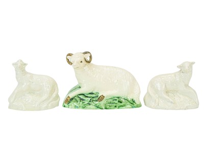 Lot 601 - A pair of English pottery press moulded figures of recumbent sheep.