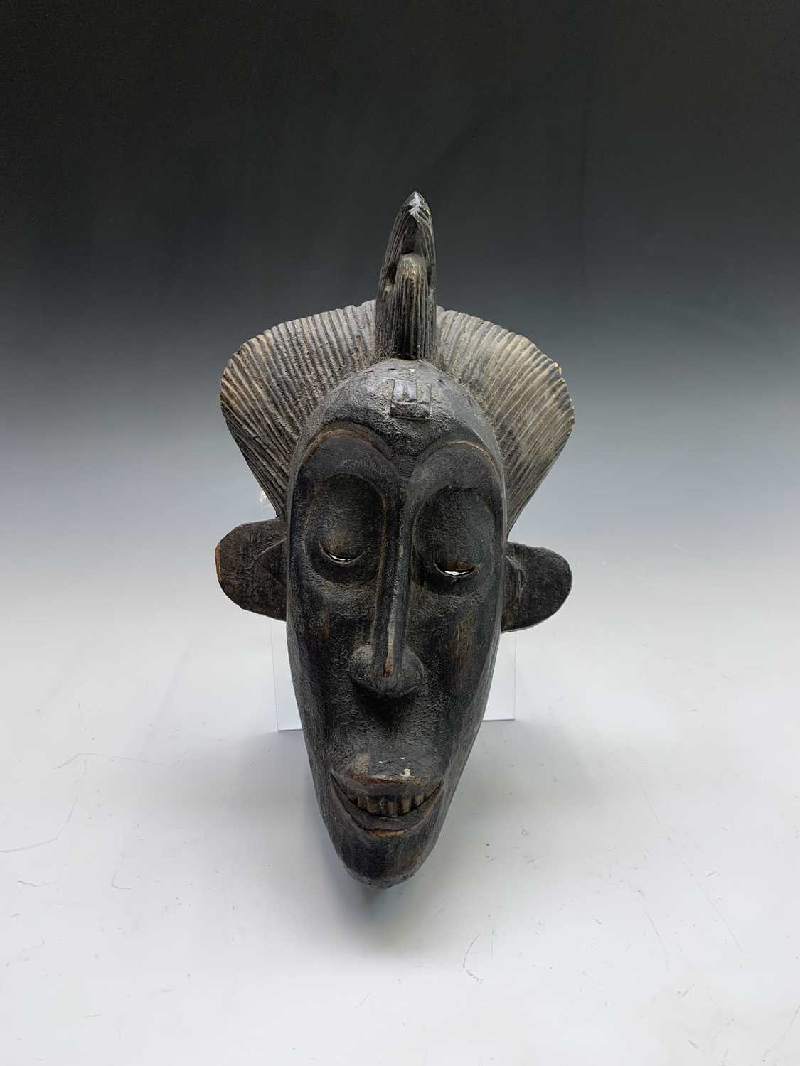 Lot 44 - A tribal carved softwood mask of slender form....