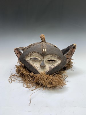 Lot 167 - An African two sided mask, with white painted...