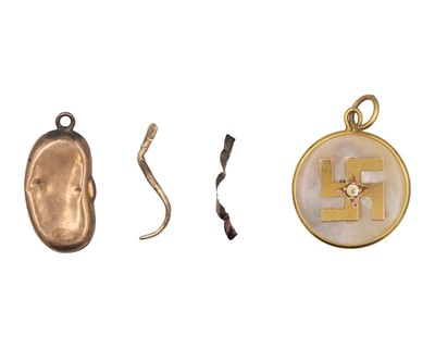 Lot 479 - A gold-mounted mother-of-pearl sauwastika charm.