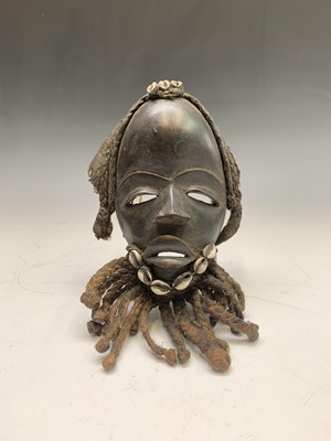 Lot 290 - An African carved wood mask, decorated with...