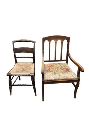 Lot 873 - An oak elbow chair.