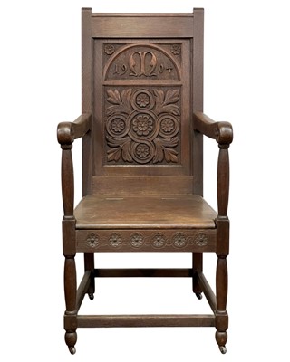 Lot 720 - A carved oak wainscot armchair.