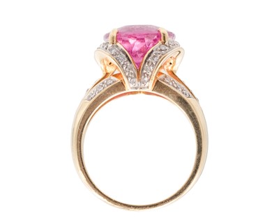 Lot 205 - An 18k dress ring, set with a large oval cut rubellite tourmaline and pavé set diamonds.