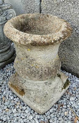 Lot 427 - A reconstituted stone urn, raised on associated base.