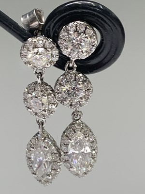 Lot 2397 - A pair of exquisite diamond earrings each of...