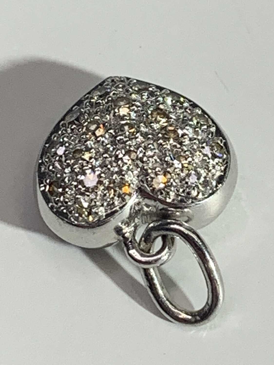 Lot 2495 - A white gold or platinum heart pendant pave...