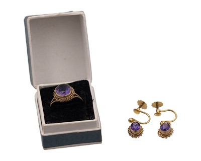 Lot 473 - A 9k oval cut amethyst set ring and pair of matching pendant earrings.