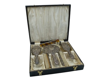 Lot 233 - A repoussé silver dressing table set by W. I. Broadway & Co.