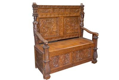Lot 723 - A late Victorian carved oak bench settle.