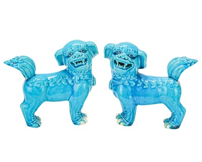 Lot 384 - A pair of Chinese turquoise glazed foo dogs or temple lions.