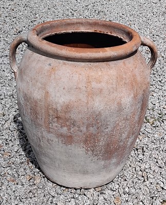 Lot 420 - A terracotta twin handled pot.