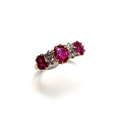 Lot 2426 - An 18ct gold ruby and diamond ring the three...