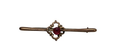 Lot 5 - A 9ct gold bar brooch with a set stone,...
