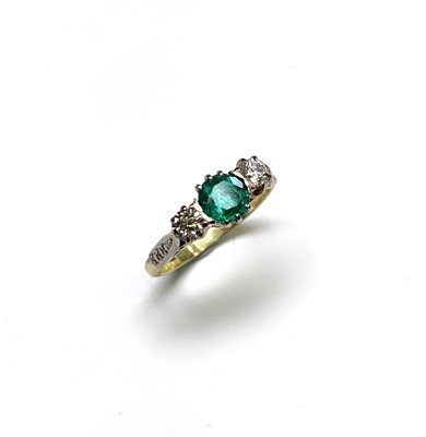 Lot 2374 - An 18ct yellow gold ring set an emerald of...