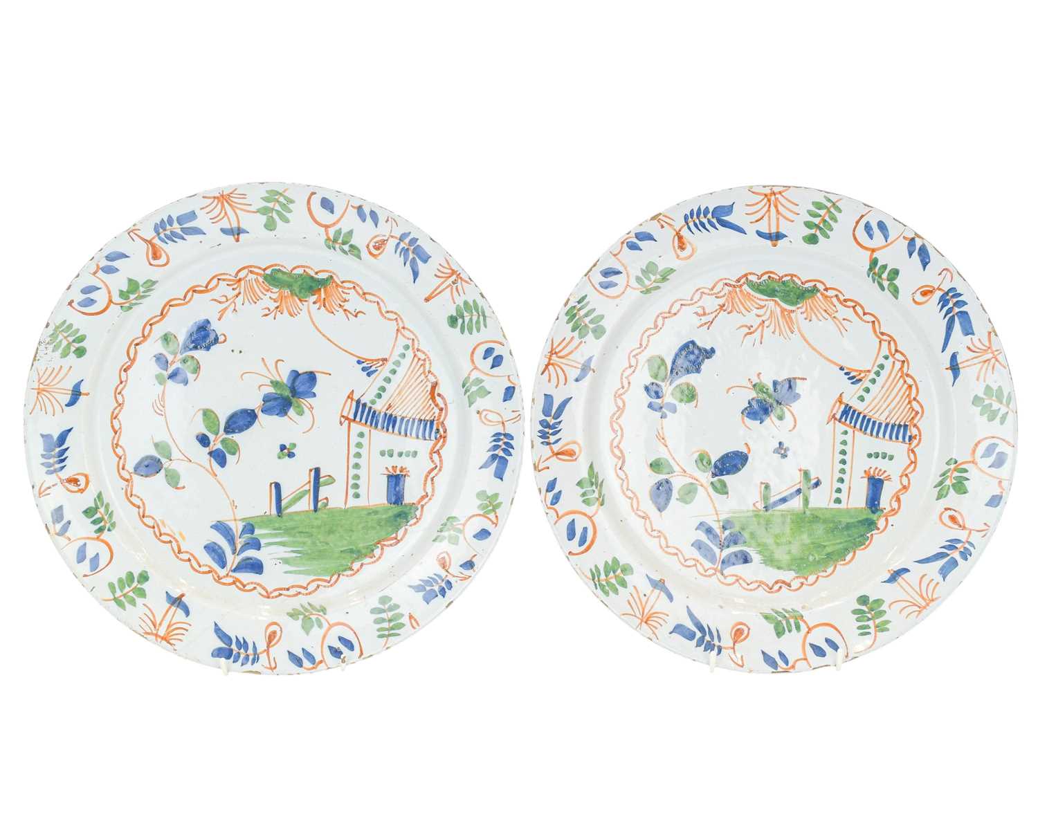 Lot 627 - A pair of English Delft polychrome chargers.