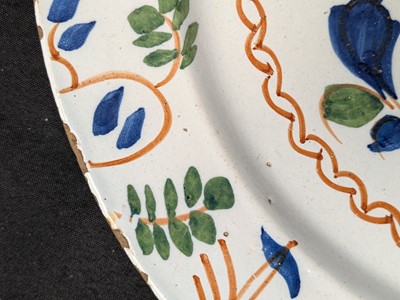 Lot 627 - A pair of English Delft polychrome chargers.