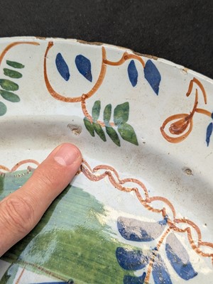 Lot 627 - A pair of English Delft polychrome chargers.