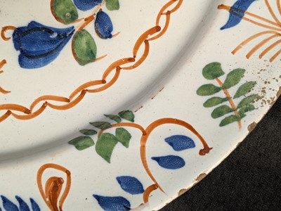 Lot 627 - A pair of English Delft polychrome chargers.