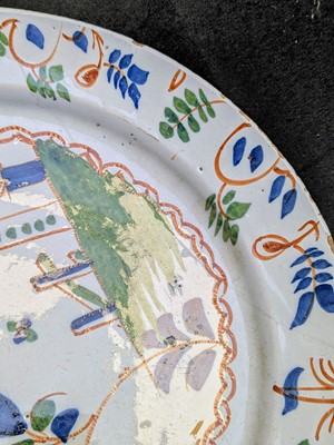 Lot 627 - A pair of English Delft polychrome chargers.